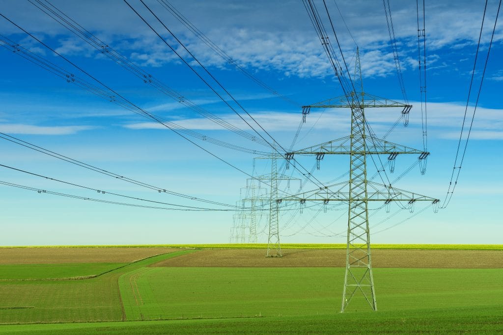 powerlines over a green field