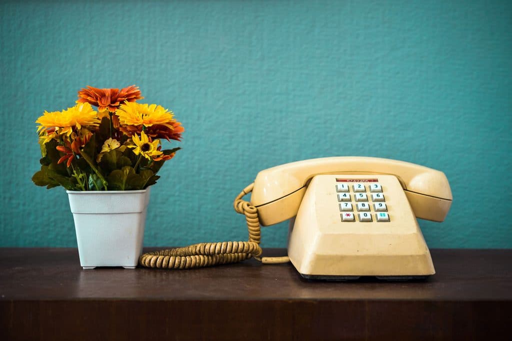 telephone and boquet of flowers on desk